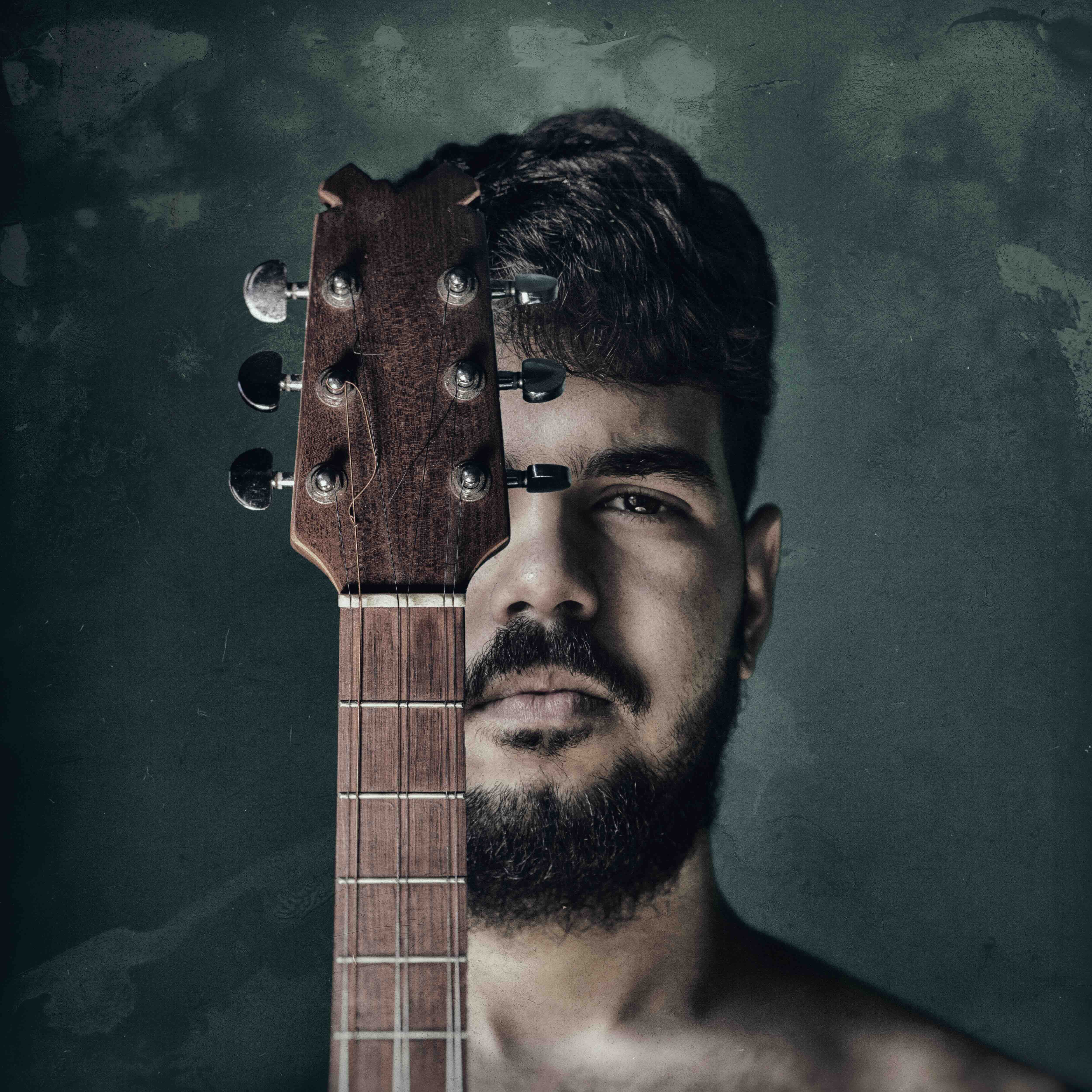 Portrait of Mario Salvador with the neck of a tres aligned down the centre of his face